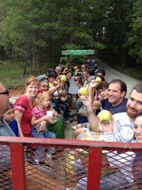 U-Pick wagon rides families back at the Apple Barn after a picking apples in the
							 orchard in Ellijay, Ga